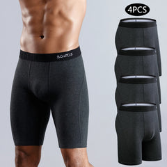 A man wears dark gray long-leg cotton boxer shorts with a branded elastic waistband.
