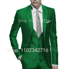 A man wears a slim-fit emerald green three-piece suit with a white shirt and silver tie.