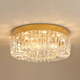 A modern gold circular ceiling light featuring tiered rectangular crystal prisms.