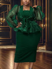A woman wears a dark green two-piece set featuring a V-neck peplum top and a midi sheath skirt.