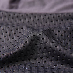 Close-up view of black breathable mesh fabric used for men's boxer shorts.