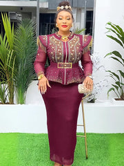 A woman wears a burgundy two-piece set featuring a beaded peplum top and a matching long skirt.