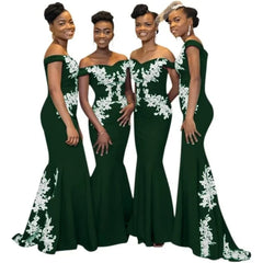 Four women wear matching floor-length dark green off-the-shoulder mermaid dresses with lace accents.