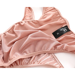A pair of pink satin men's briefs with a black size M tag.
