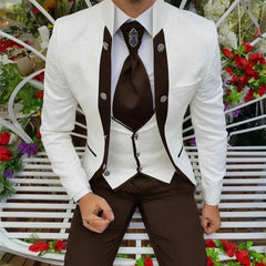 A man wears a white patterned jacket with brown lapels, a white vest, and brown trousers.