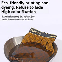 A pair of brown plaid boxer shorts with a black elastic waistband soaking in a metal bowl.