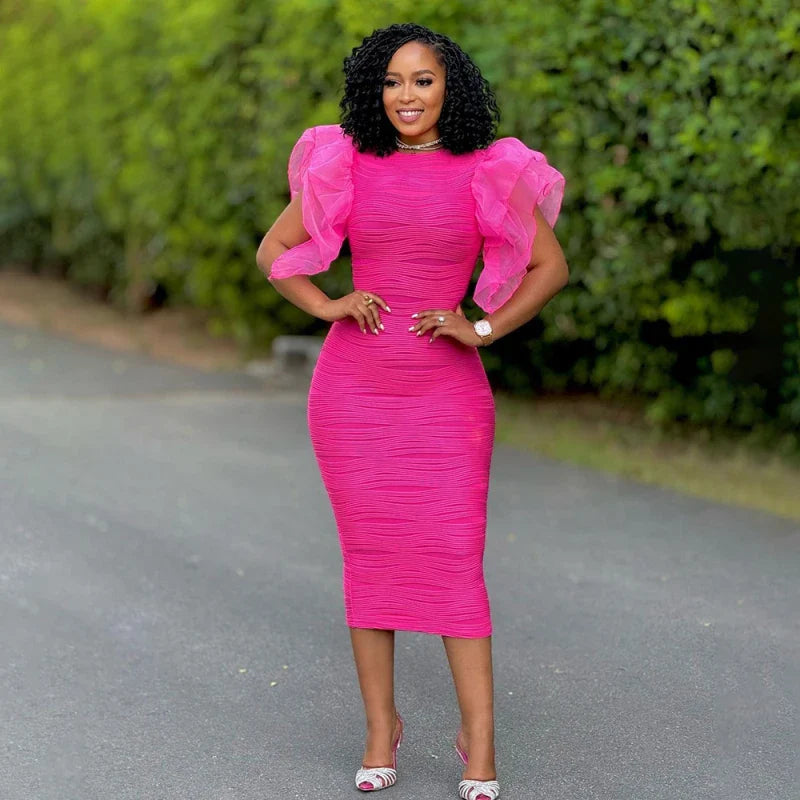 A woman wears a hot pink, mid-calf bodycon dress with ruffled butterfly sleeves and a round neck.