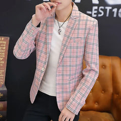 A man wears a slim-fit pink and white plaid blazer with a single-button closure.