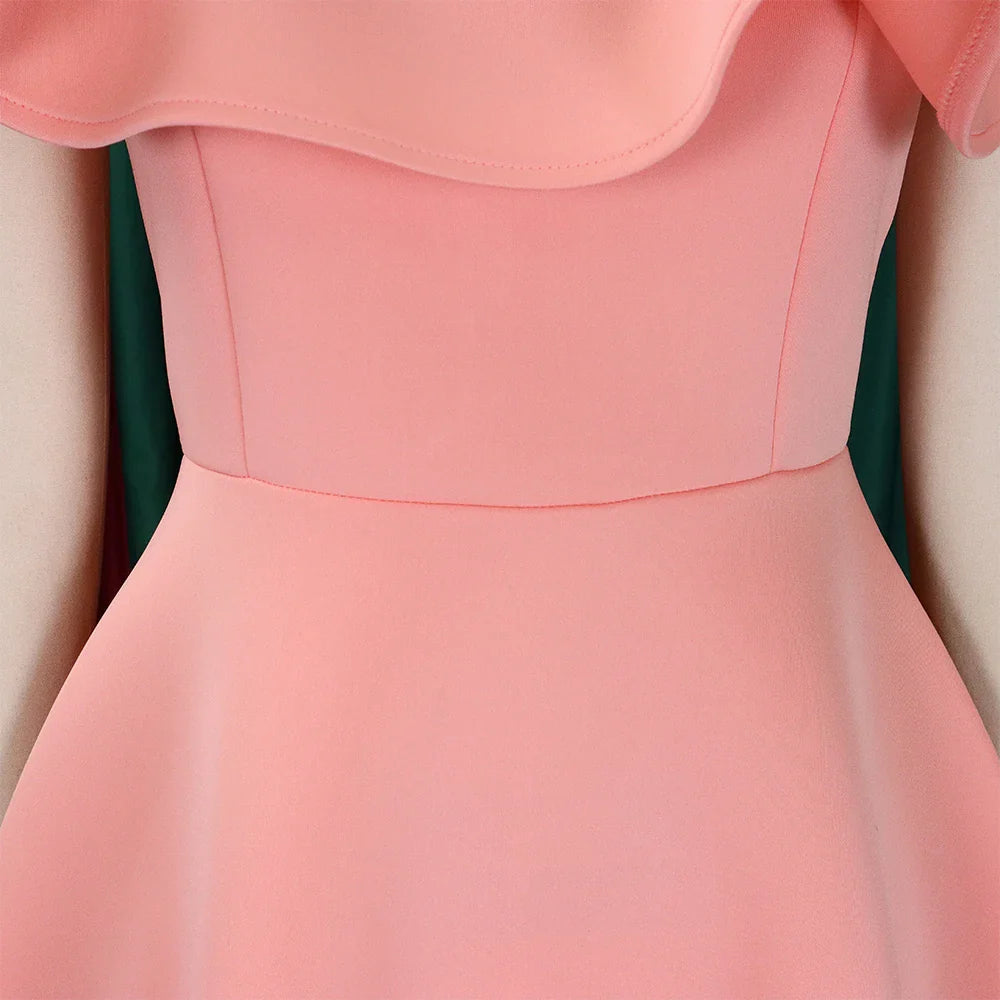 A close-up of a peach-colored A-line dress featuring a ruffled neckline and a high waist.