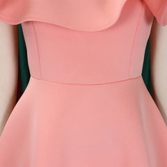 A close-up of a peach-colored A-line dress featuring a ruffled neckline and a high waist.