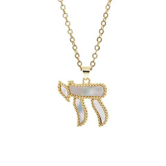 A gold-toned copper necklace featuring a Chai pendant inlaid with white mother-of-pearl.