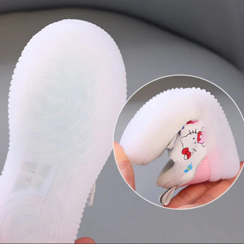 A pair of Hello Kitty themed children's sneakers with flexible, translucent light-up soles.