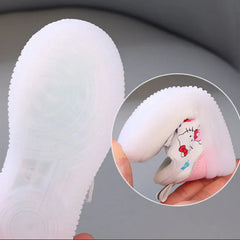 A pair of Hello Kitty themed children's sneakers with flexible, translucent light-up soles.