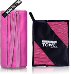 A pink microfiber sports towel shown folded next to its black and pink mesh carrying pouch.