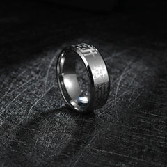 A silver-toned stainless steel ring engraved with Spanish text and a cross design.