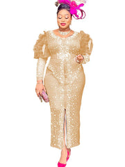 A woman wears a gold, ankle-length sheath dress with puff sleeves, diamond embellishments, and a belt.