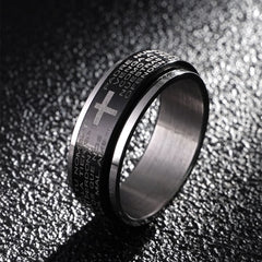 A black titanium steel ring featuring an engraved Christian cross and Spanish prayer text.