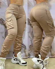 A pair of beige ankle-length cargo pants featuring side pockets, a chain detail, and cuffed hems.