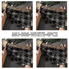 A set of four black boxer shorts featuring a white dragon print and a gold patterned waistband.