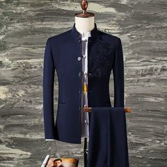 A navy blue slim-fit suit featuring a stand collar blazer with dragon embroidery and matching pants.