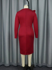 A back view of a solid red knee-length sheath dress with long sleeves and a zipper closure.