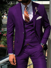A man wears a vibrant purple three-piece suit with a white shirt and a striped orange tie.