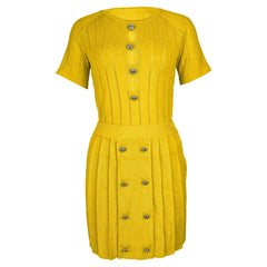 A yellow two-piece knitted set featuring a short-sleeve top and a button-detailed mini skirt.