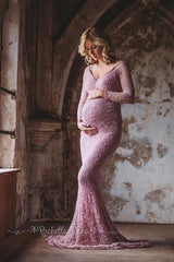 A pregnant woman wears a long-sleeved, V-neck, dusty pink lace mermaid maternity gown.