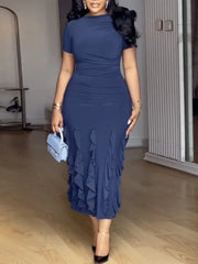 A navy blue short sleeve midi dress featuring a slim fit, ruched waist, and layered ruffle hem.
