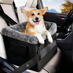 A portable black dog booster seat with a grey plush interior sits on a car seat.
