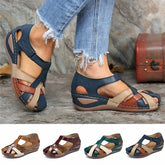 A pair of women's multi-colored leather sandals with a closed-toe design and low wedge heel.