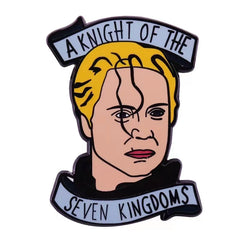 A metal enamel pin featuring a stylized illustration of Brienne of Tarth with text banners.