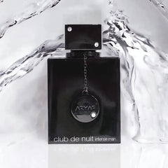 A black rectangular bottle of Armaf Club de Nuit Intense Man perfume with a decorative chain.