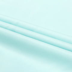 A close-up view of light blue twill fabric with a smooth, diagonal weave texture.