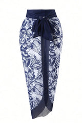 A navy and white floral print sarong cover-up with a tie-front waist.