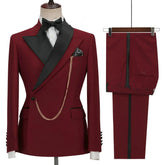 A burgundy double-breasted men's suit with black lapels, a gold chain, and matching trousers.