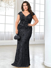 A plus-size woman wears a black floor-length mermaid evening dress with sequins and a V-neck.