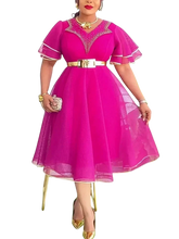 A woman wears a magenta midi dress with ruffled sleeves, a gold belt, and beaded neckline detail.