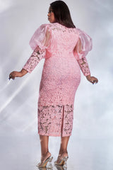 A woman wears a pink lace midi dress with sheer puff sleeves and a back slit.