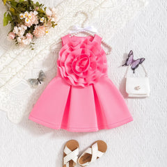 A sleeveless pink A-line dress for toddlers featuring a large fabric flower on the bodice.
