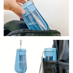 A portable blue pet water bottle with a flip-top design and a carrying strap.