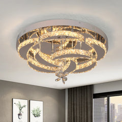 A modern flush mount ceiling light featuring concentric rings of K9 crystal and LED lighting.