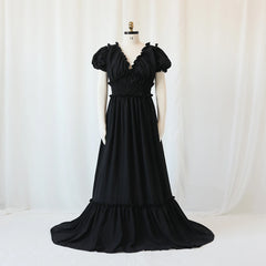 A black bohemian maternity maxi dress with a V-neck, ruffled sleeves, and a smocked waist.