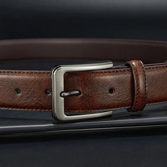 A brown genuine leather belt for men featuring a brushed silver alloy needle buckle.