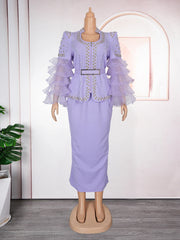 A lavender two-piece set featuring a beaded jacket with ruffled sleeves and a matching long skirt.