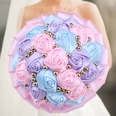 A round wedding bouquet of silk roses in pastel pink, blue, and purple accented with silver beads.