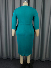 A back view of a teal midi-length sheath dress with long sleeves and a peplum waist.