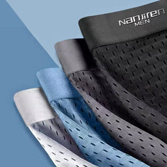 A stack of four breathable mesh boxer shorts in black, grey, blue, and white.