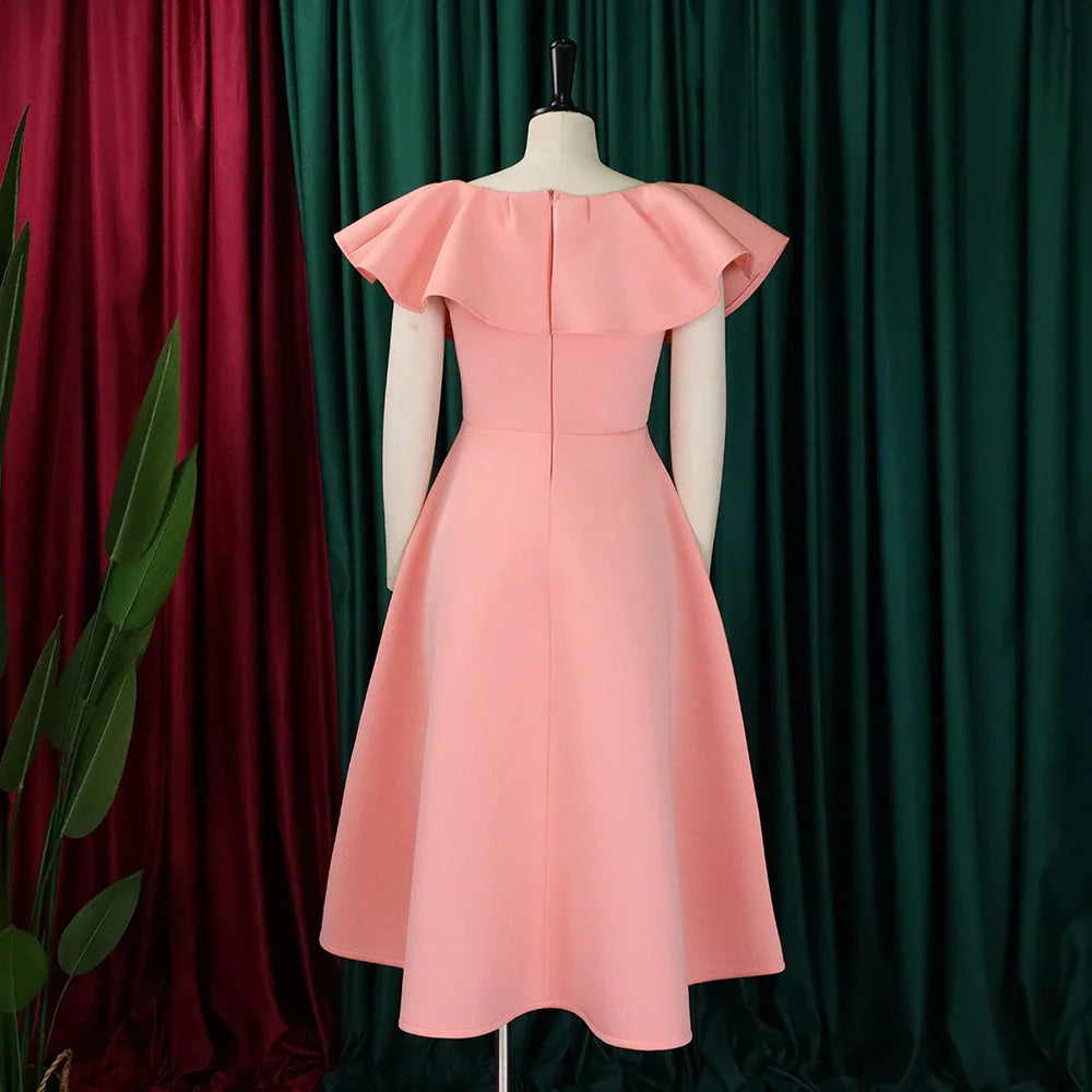 A peach-colored A-line midi dress with ruffled sleeves shown from the back on a mannequin.