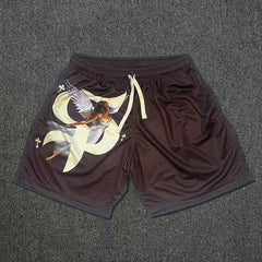 Black mesh basketball shorts featuring a graphic of a winged goddess and small cross symbols.